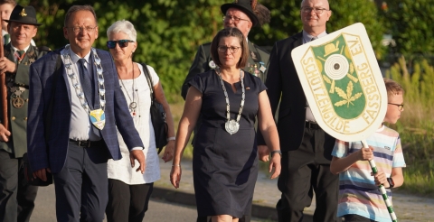 Wizyta delegacji z Dusznik w Fassberg. Przemarsz delegacji. Na pierwszym planie Wójt Gminy Duszniki i Burmistrz Fassberg oraz herb bractwa z Fassberg. Na dalszym planie radni z gminy Dusznik i bracia kurkowi. 